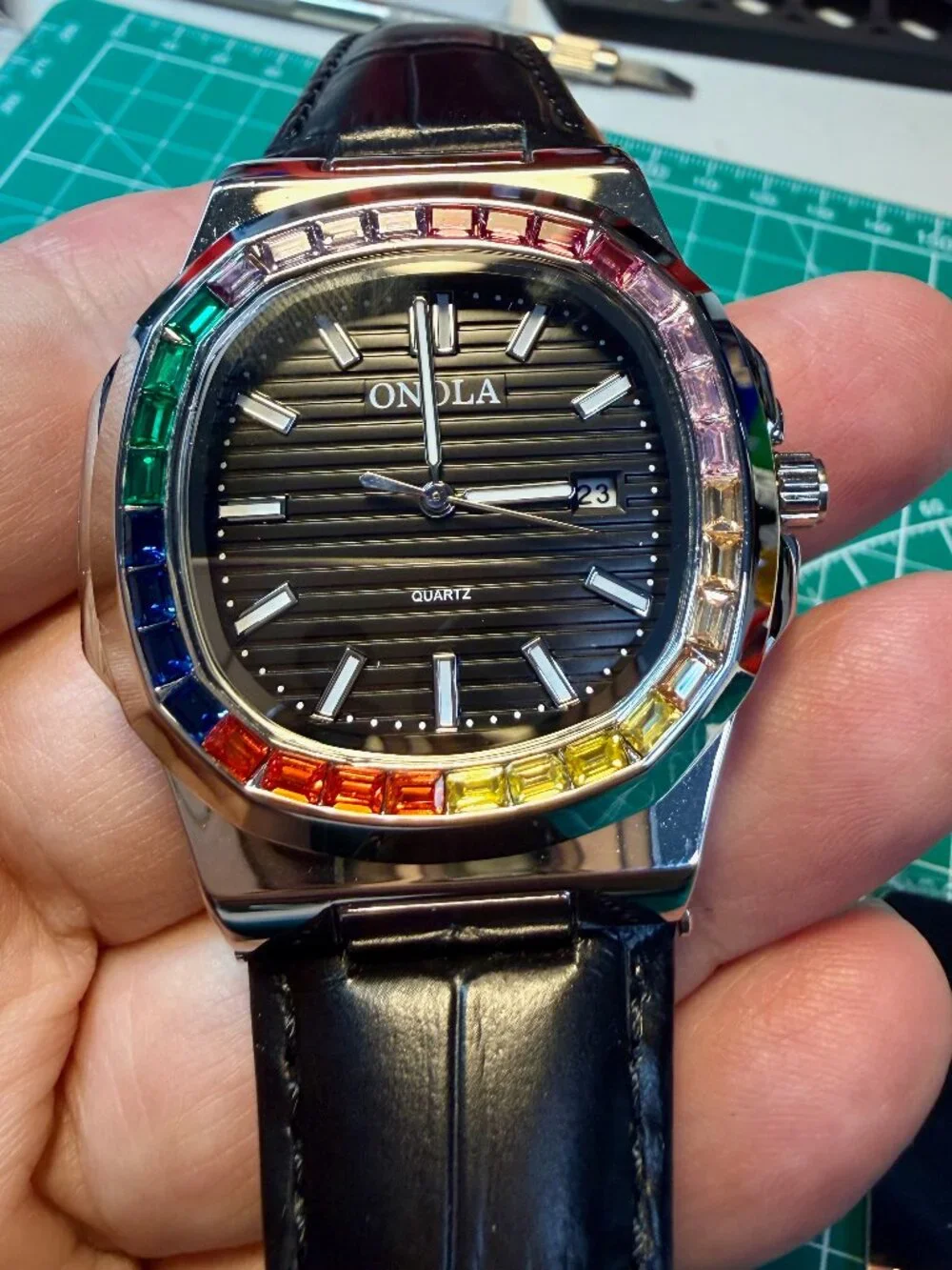 Onola quartz men's watch silver and black leather strap. Rainbow Gems Bezel.